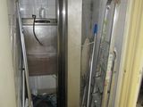 an image of a kitchen with a stainless steel refrigerator in the corner