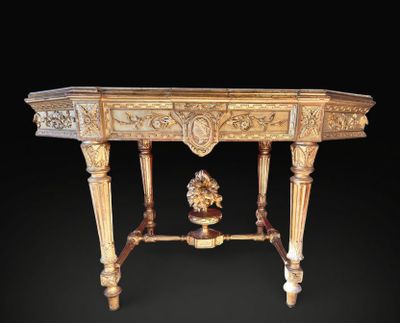 an ornately carved table with a vase on top of it