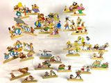 a lot of disney figurines on display in a display case
