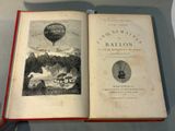 an open book with a picture of a hot air balloon in the background