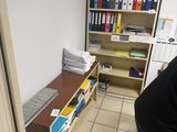 a man that is standing in a room with a book shelf