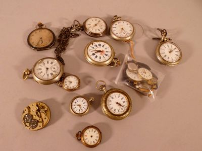 many different types of pocket watches on the table