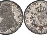a silver coin with a crown on the front and a crown on the back
