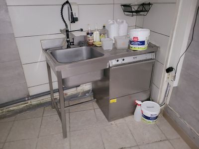 a kitchen with a sink and a dishwasher in it