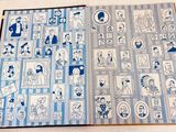 an open book with blue and white pictures on it