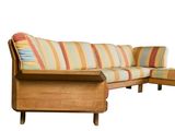 a wooden couch with a colorful striped cushion on it