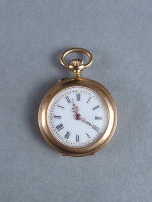 a gold pocket watch with roman numerals on it