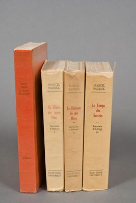 three books sitting on top of each other on a gray surface