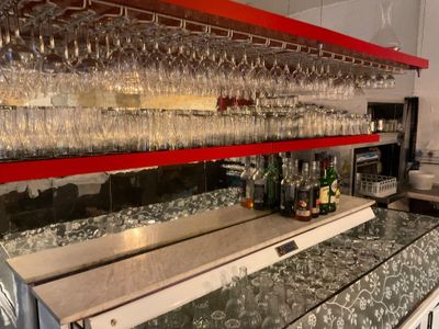 a bar with a lot of wine glasses on it