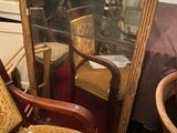 a mirror and a chair in a room with a red carpet