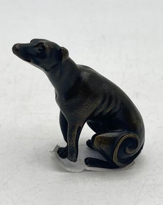 a small statue of a dog that is sitting on the ground