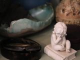 a statue of a woman sitting on top of a book
