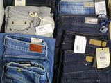 a lot of jeans that are on display in a store