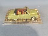 a yellow toy car in a clear plastic box