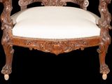a wooden chair with a white cushion on it