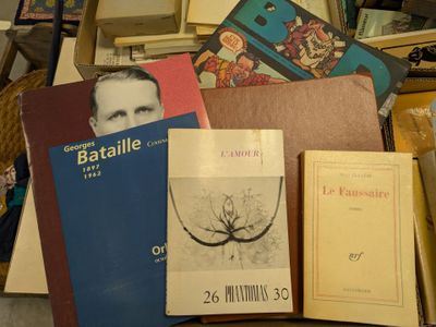 a pile of books and other items sitting on a table