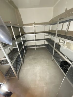 a room with a lot of shelvings and shelves in it