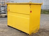 a large yellow dumpster sitting in front of a building