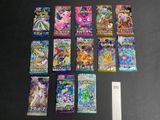 a lot of pokemon cards on the table next to a ruler