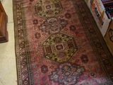 a rug on the floor in a room with many boxes of books