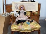 a doll that is sitting on a chair in a room