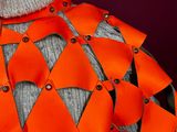 an image of a mannequin wearing an orange and black outfit
