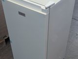 a white refrigerator that is sitting in a warehouse