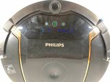a black and gold robot that is sitting on a white surface