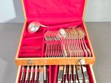 a wooden box with a set of silverware in it