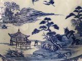 a blue and white plate with a bird on it