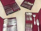 a lot of silverware in a case on the table