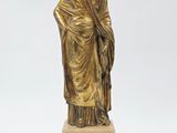an image of a statue of a woman standing on a marble base