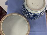 a blue and white bowl and a blue and white bowl on a blue cloth