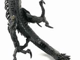 a statue of a dragon that is sitting on a white surface
