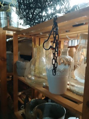 a wooden shelf with a bunch of glass vases on it