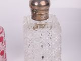 pair of pink and clear glass perfume bottles on a white surface