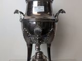 a silver plate with a lid on a stand