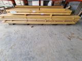 a close up of a pile of wooden planks in a warehouse