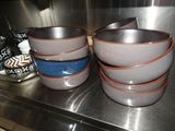 four bowls sitting on a counter in a kitchen