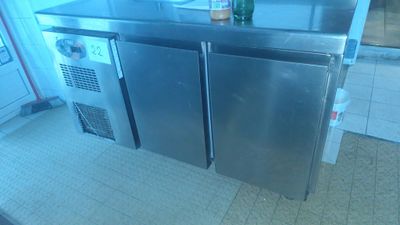 a stainless steel counter with a bottle on top of it