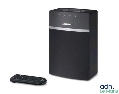bose music system with remote and remote control in front of a white background