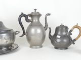 five different types of silver teapots on a white background