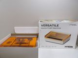 a box with a picture of a home craft machine inside of it