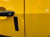 a close up of a door handle on a yellow car