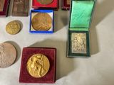 a lot of gold and silver medals on a table