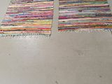 two rugs that are on the floor in the room