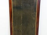 an old wooden framed mirror sitting on top of a floor next to a wall