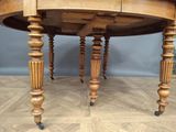a wooden table with a drawer underneath it on wheels