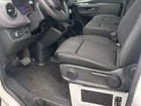 the interior of a van with the door open and the driver ' s seat down