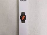 an orange and black apple watch sitting on top of a white box